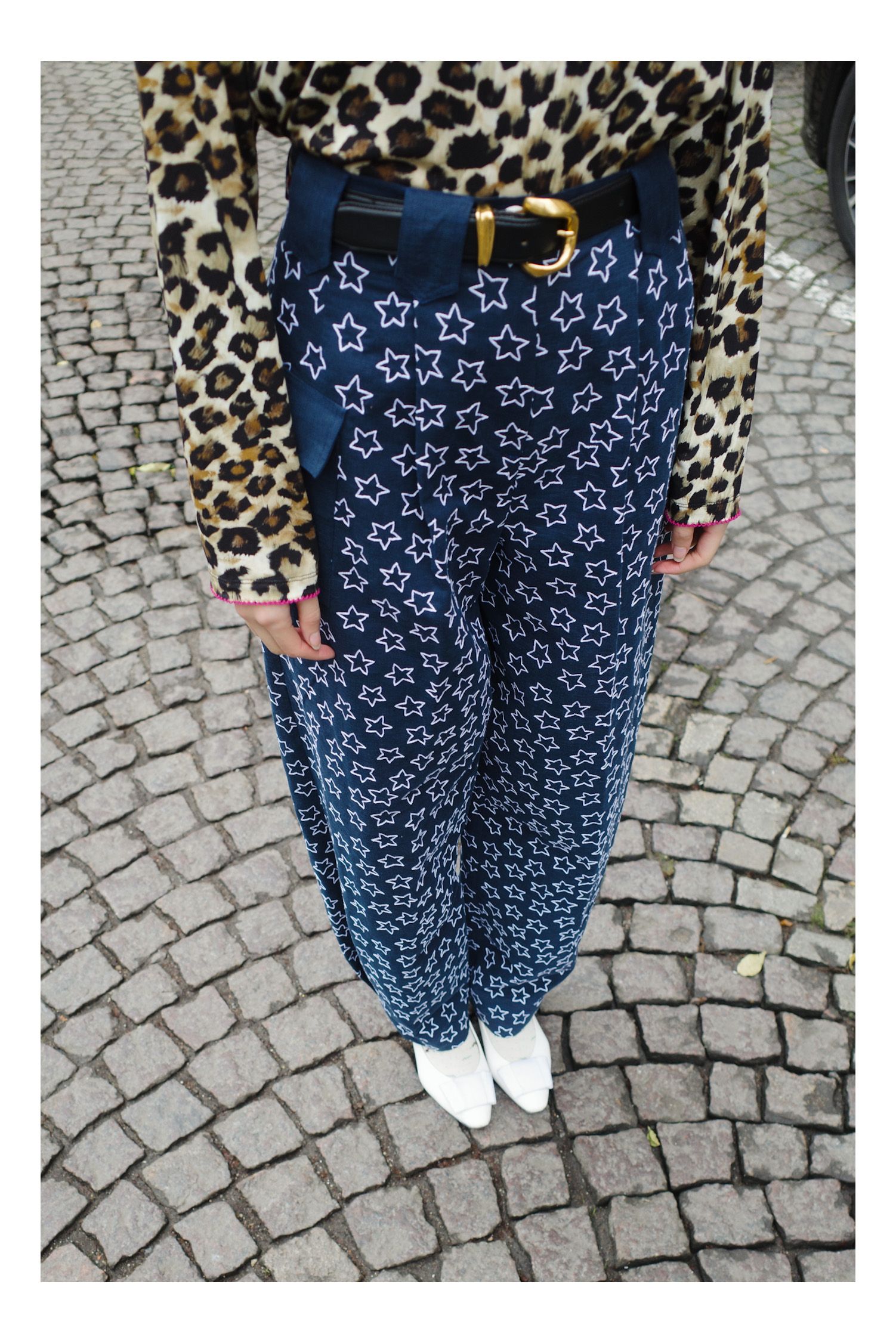 Image may contain clothing, pants, jeans, adults, cars, traffic and vehicles