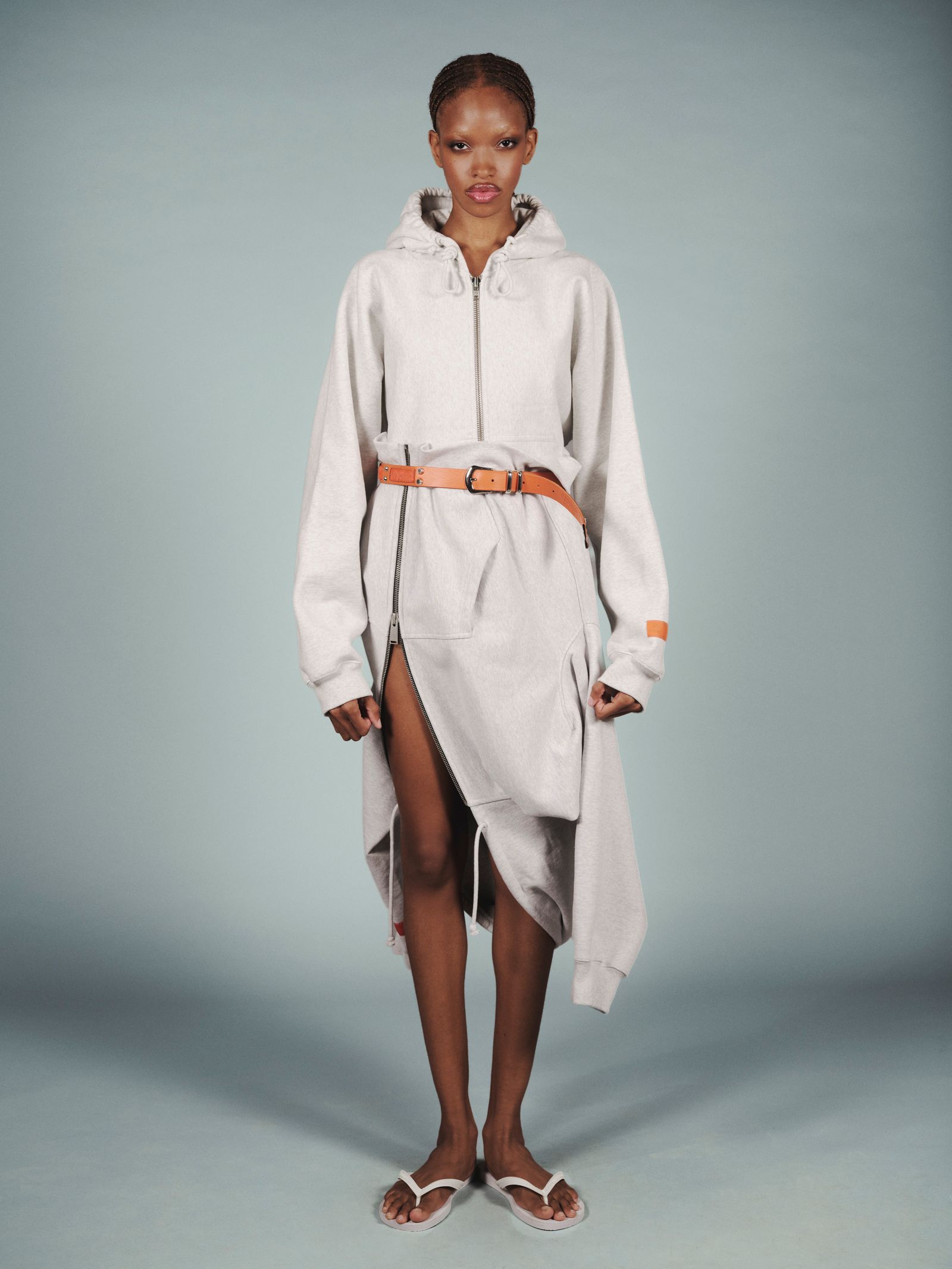 Image may contain fashionable clothing, robes, coats, footwear and sandals