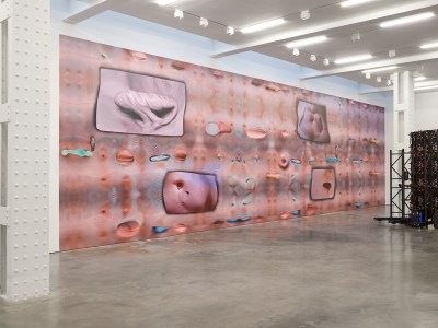 A mural depicting wrinkled skin and a hole in the chest.