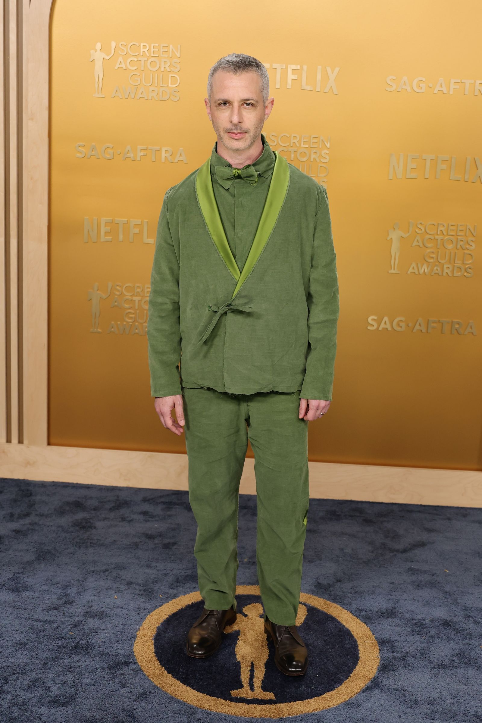 Image may contain Jeremy Strong standing adult clothing, formal suits and jackets