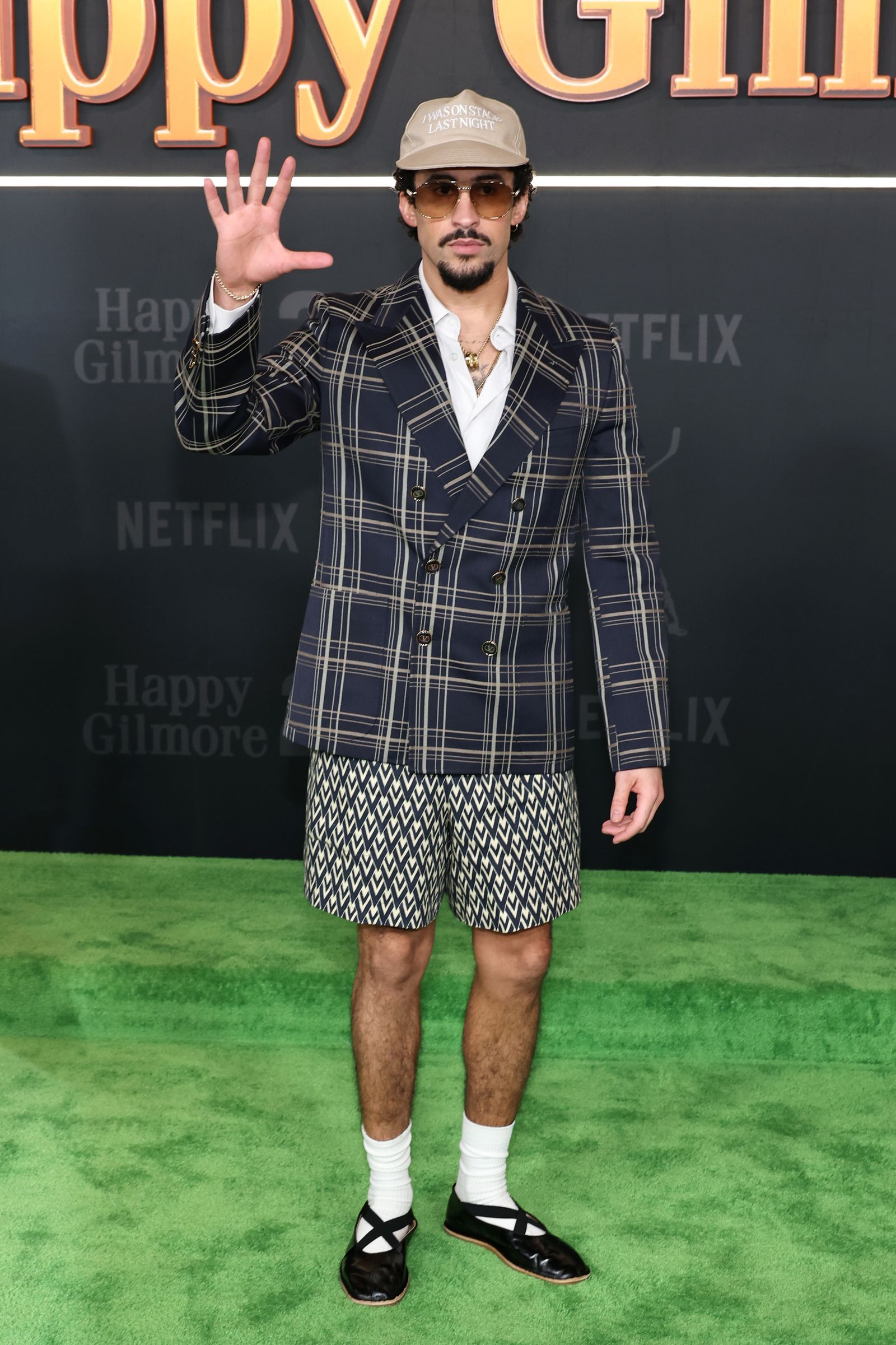 Image may contain Bad Bunny clothing, outerwear, adult stand-ups, shorts and beachwear