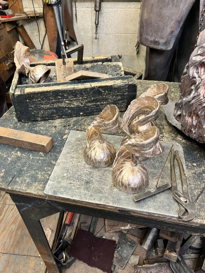 Floral sculptures on a work bench. 