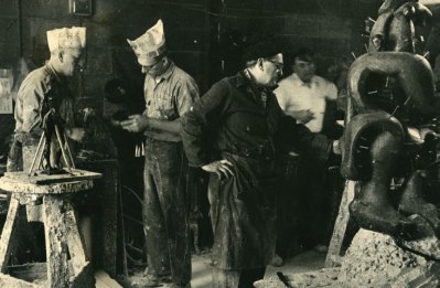 Workers at a foundry working on sculptures. 