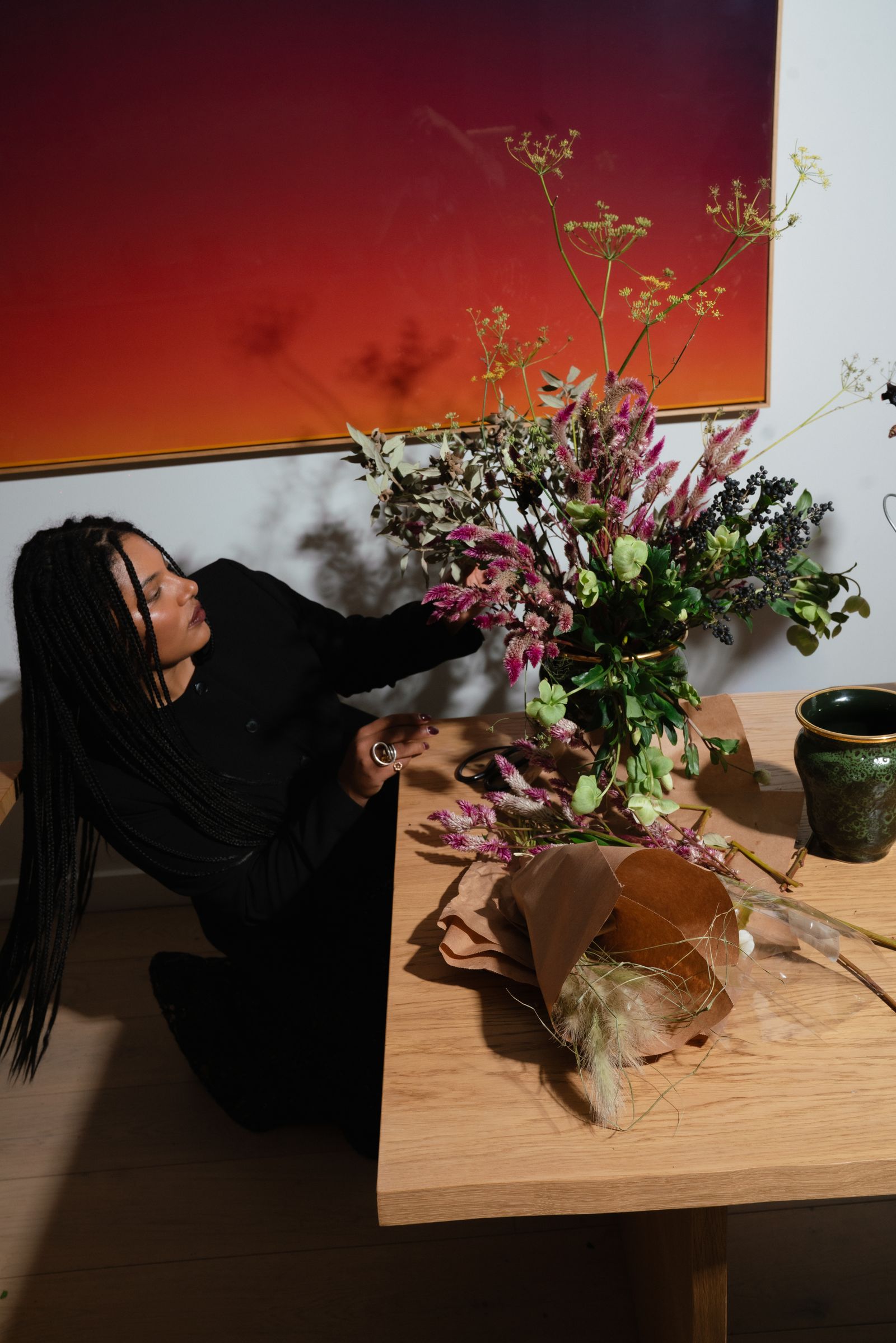 Pictures may contain flower arrangements, plants, bouquets, ikebana, adult furniture, tables and headsets