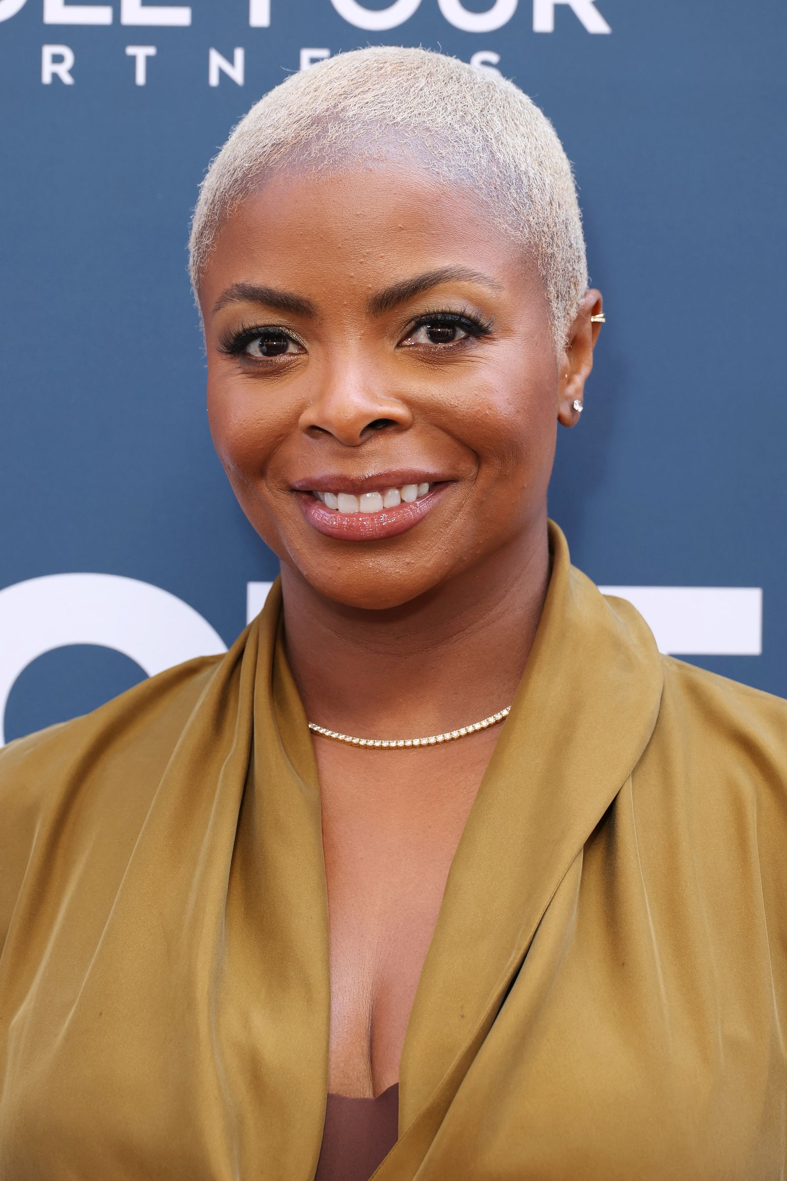 Image may contain blond hair, head, face, body parts, neck, adult accessories, jewelry and necklaces