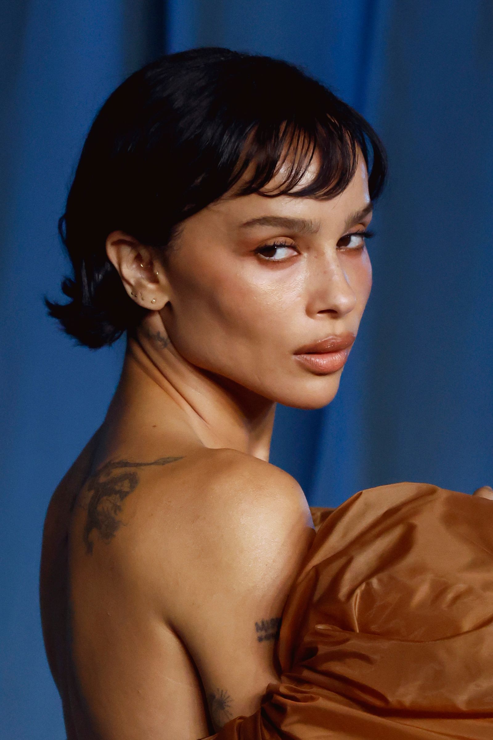 Image may contain Zoë Kravitz face, head, person, black hair, hair, body part, neck, adult, shoulder, skin and tattoos