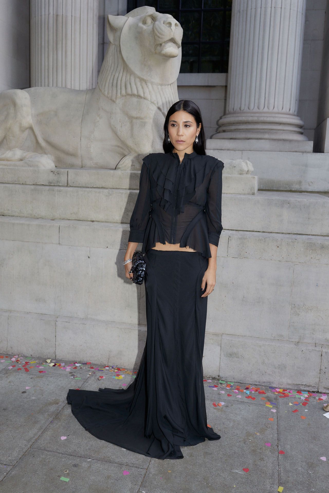 Image may contain adult clothing, dress, sleeves, formal, brunette, hair, fashion, standing, animals and lion