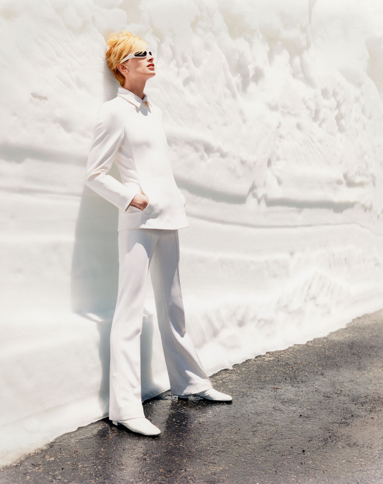 Image may contain Kristen McMenamy clothing, formal wear, blonde hair, people, pants and standing