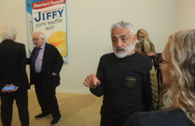 A man speaking in a crowd.