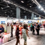 An art fair with people lounging on chairs.