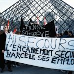 Museum staff hold banners and union flags outside the entrance to the Louvre at the world-famous museum on December 15, 2025 in Paris, France, as workers voted to go on strike to protest deteriorating working conditions and declining visitor experience at the world-famous museum. (Photo: Jerome Gilles/NurPhoto via Getty Images)