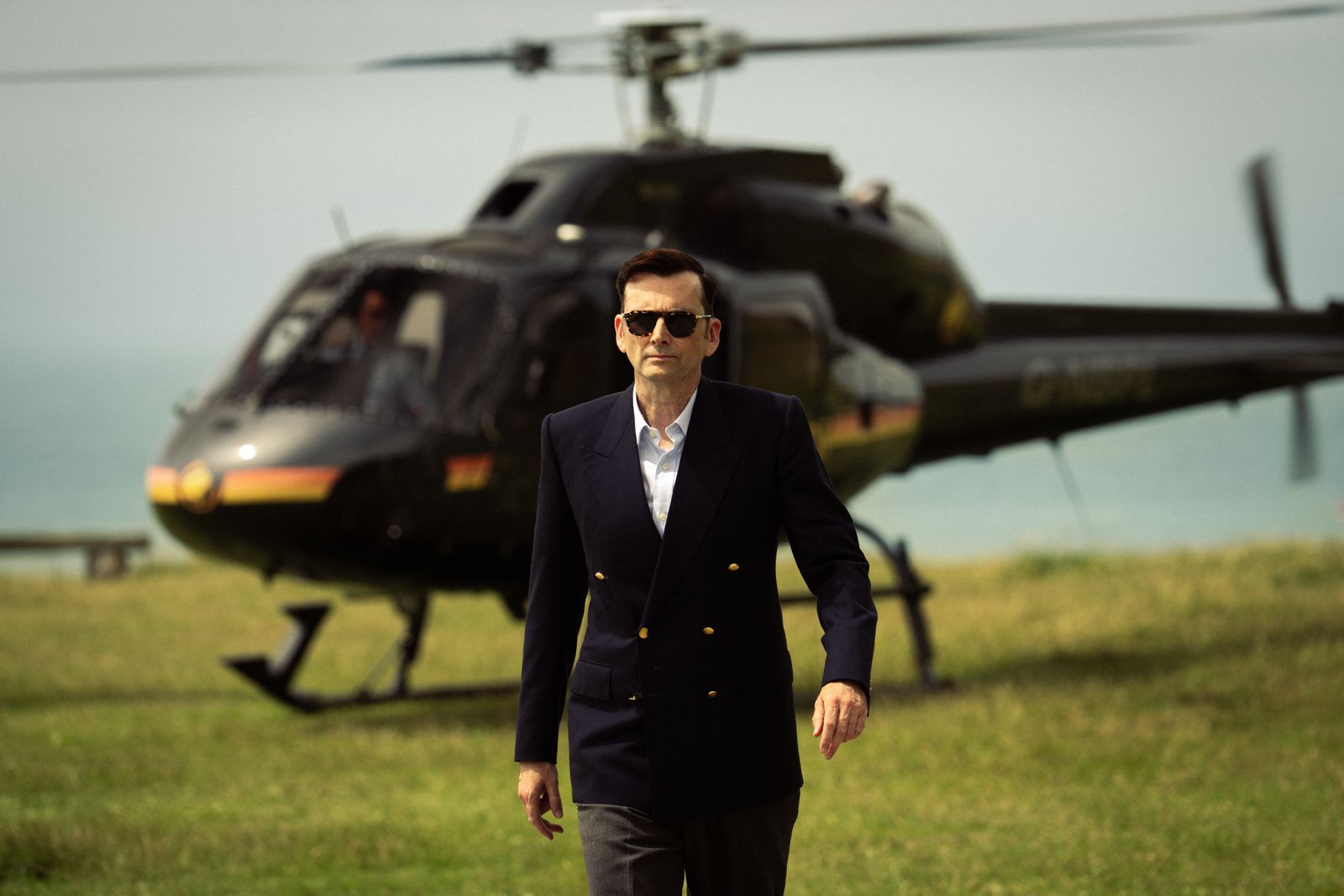Image may contain David Tennant blazer, coat, jacket, airplane, helicopter, transport and adult