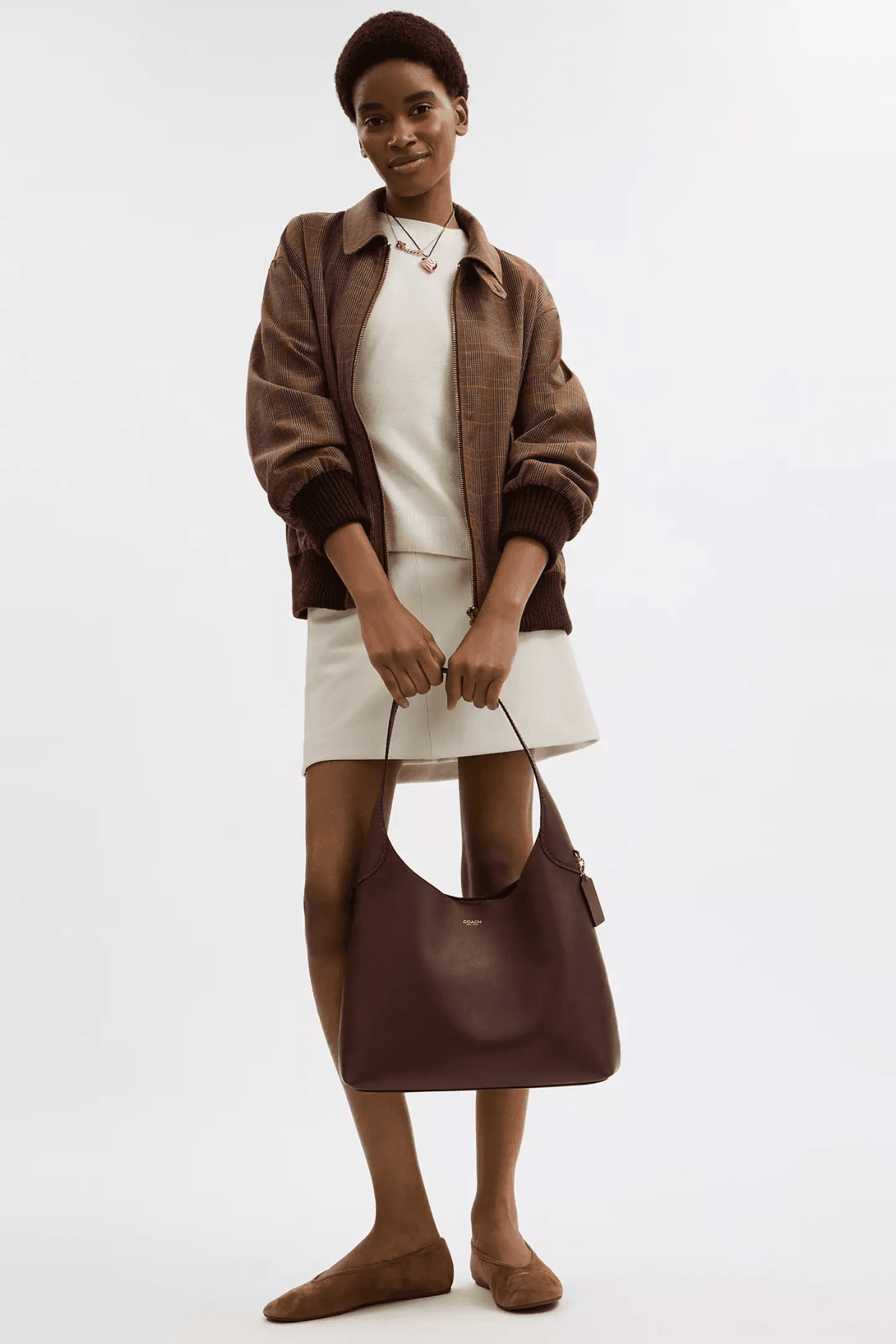 Image may contain clothing, coats, accessories, bags, handbags, jackets, blazers, dresses, adults and purses