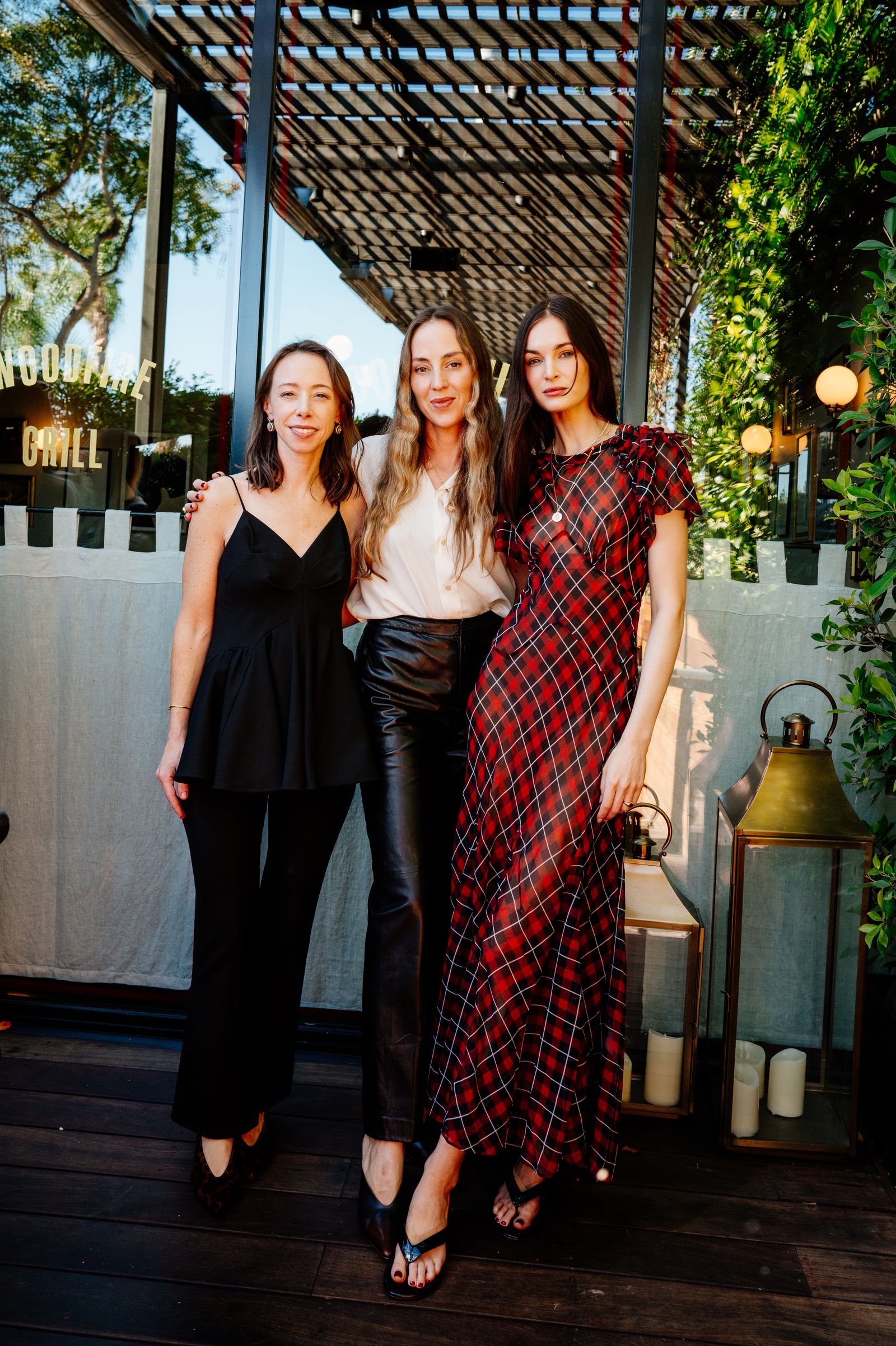 Image may contain potted plants, shirts, clothing, adults, dresses, pants, faces, head photography and portraits