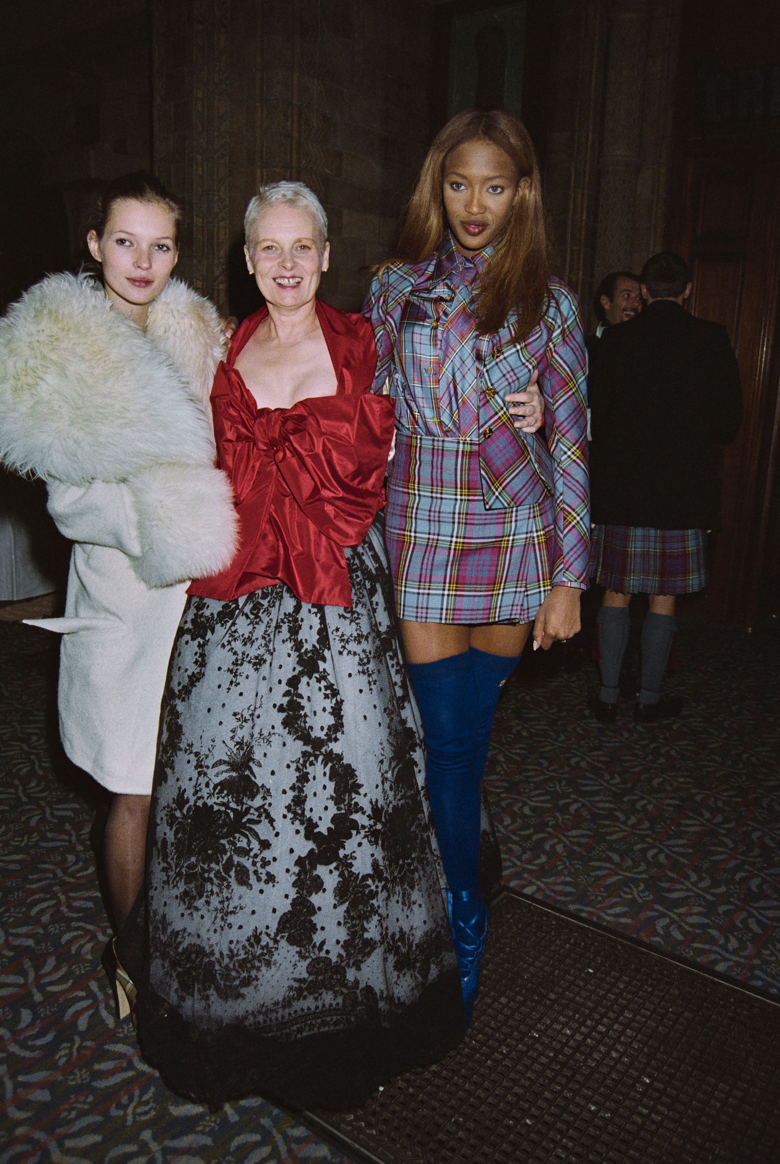 Image may contain Naomi Campbell Kate Moss Vivienne Westwood clothing skirt shirt coat people jacket and face