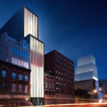 A towering gallery building borders the street, and out-of-focus cars whiz by.