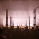 People dance in a smoky nightclub.