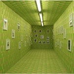 Green room with photos on the wall.