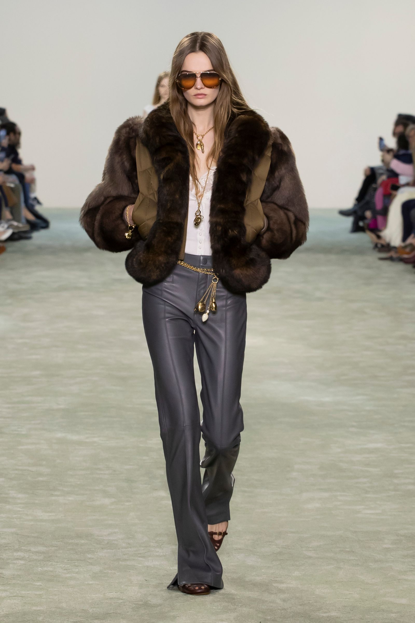 Image may contain Lucy Evans clothing, pants, accessories, jewelry, necklaces, coats, adults, jackets and furs