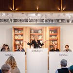 A woman stands on the podium during the auction.