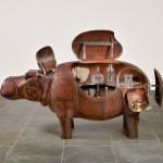 Metal sculptures, in the case of a hippopotamus, with bottles and other objects inside.