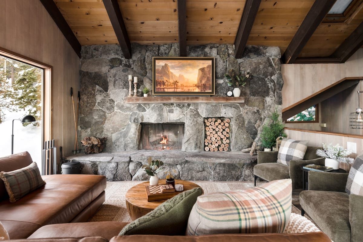 Pictured may contain fireplace interior home decor interior design fireplace plants candles art paintings and chairs