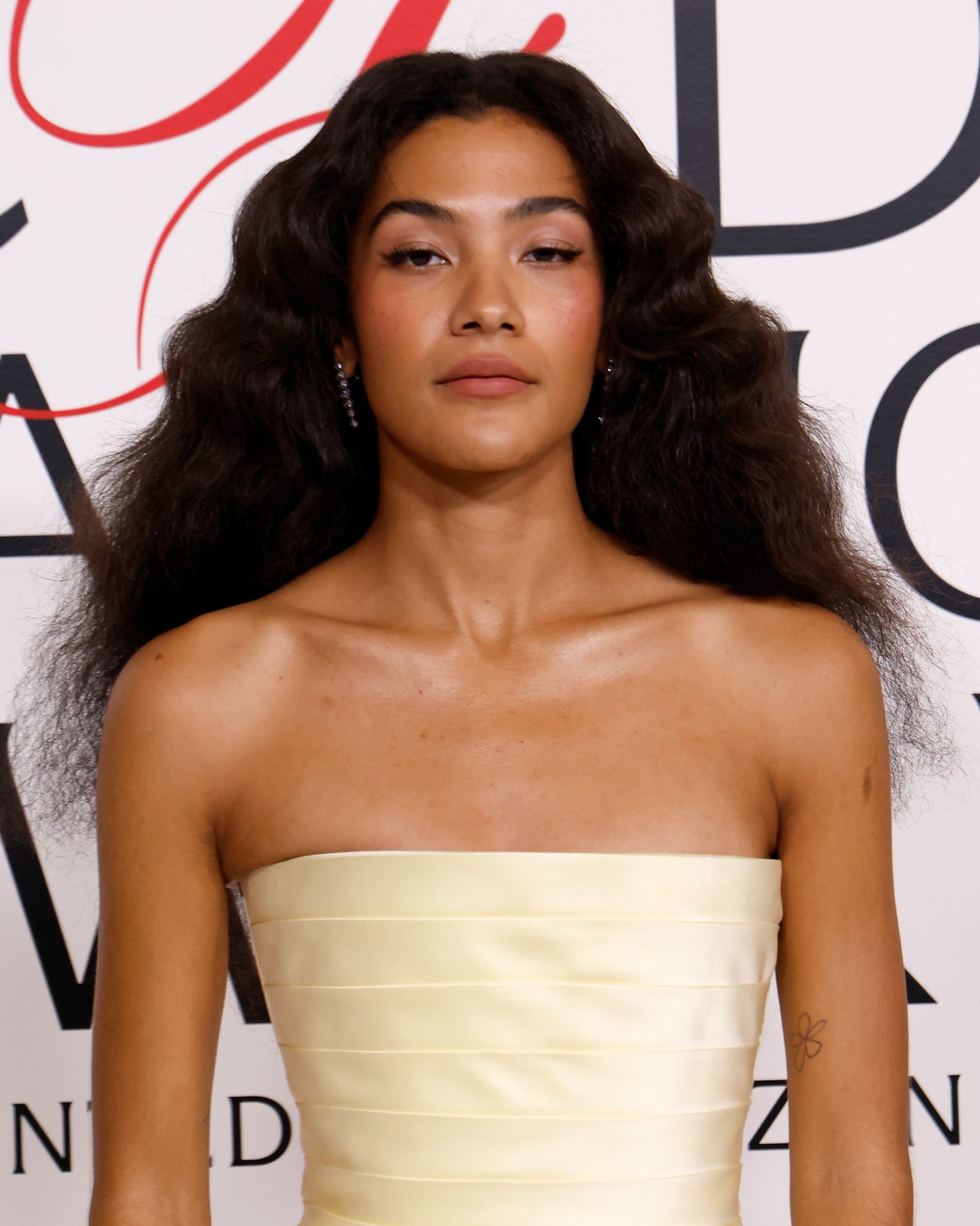 Image may contain black hair, hair, human heads, faces, adults, body parts, neck and shoulders