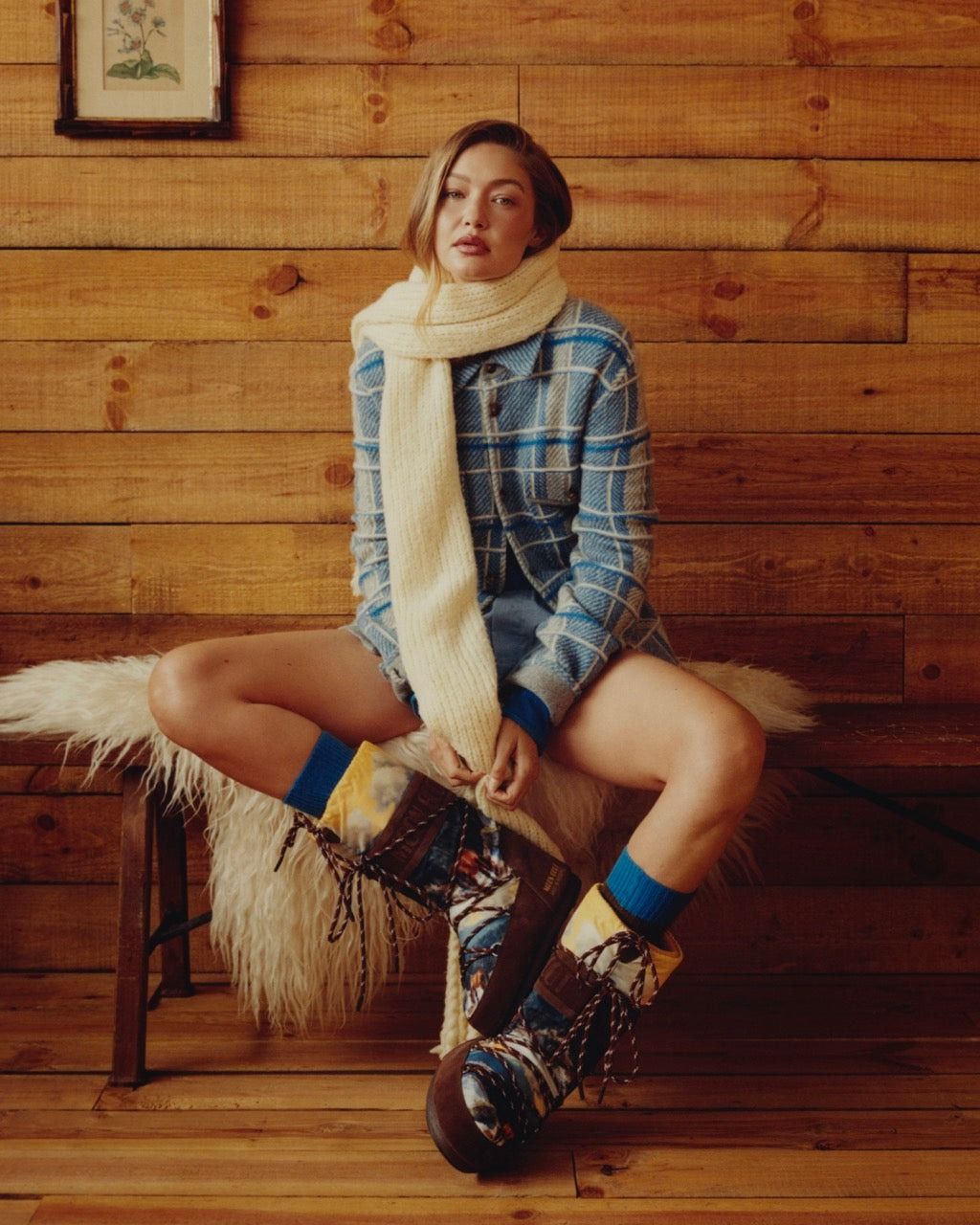 Image may contain Gigi Hadid clothing, footwear, sitting, body parts, knees and adults