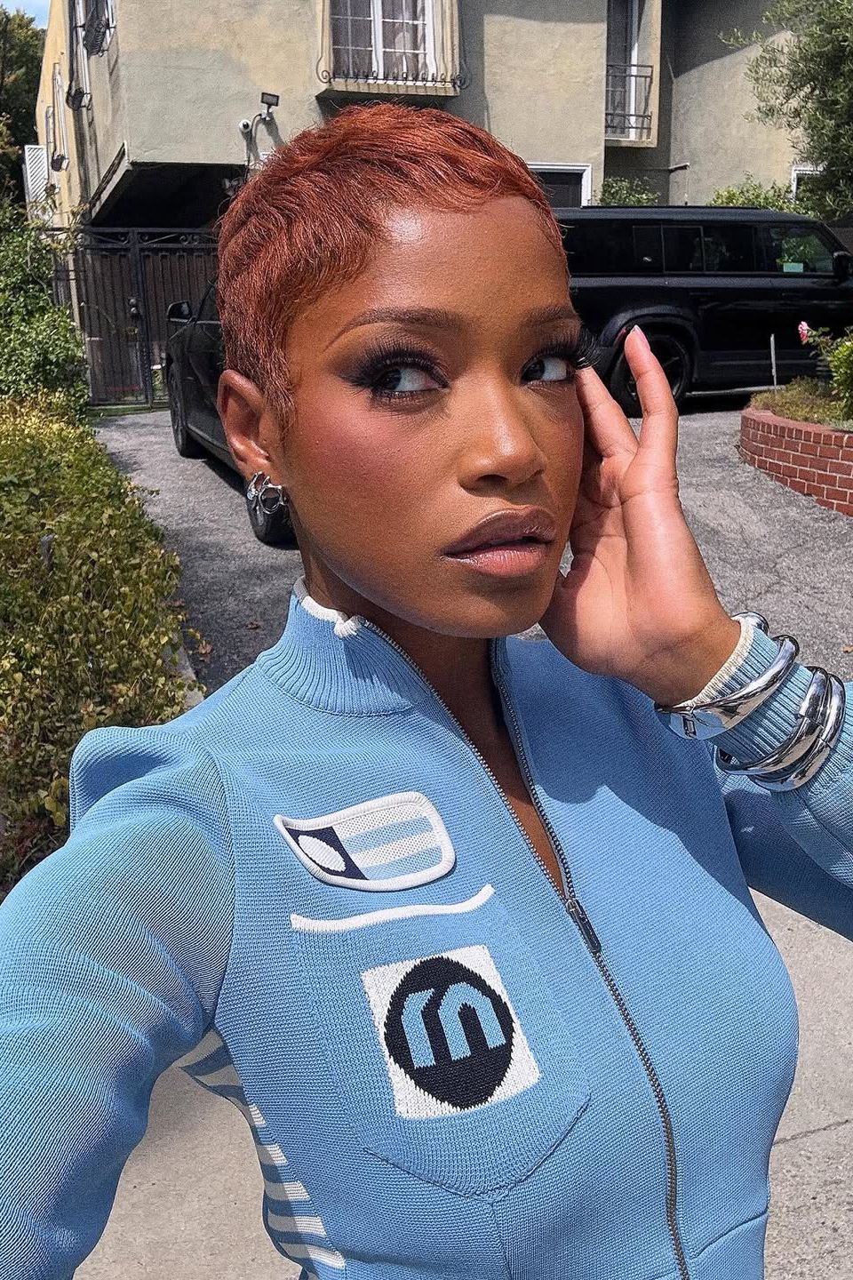 Image may contain Keke Palmer hair, people Adult Car Transport Vehicle Pixie Cut and brown hair