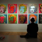 LONDON - OCTOBER 10: A visitor looks at Andy Warhol's 