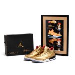 Gold Nike Air Jordan 3 and design paraphernalia.