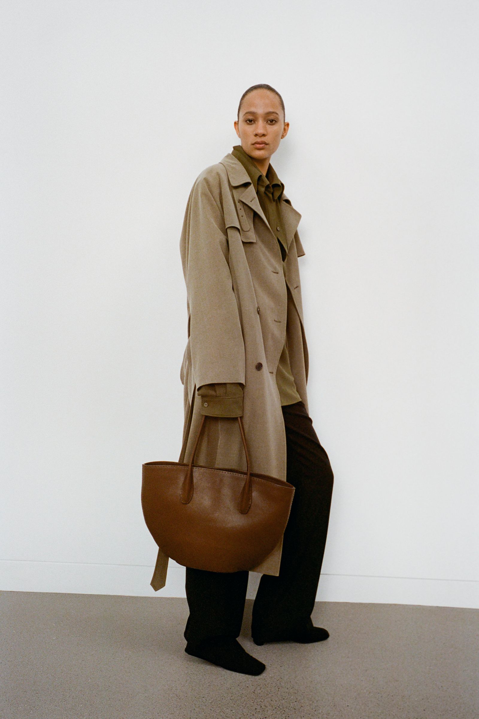 Image may contain clothing, outerwear, accessories, bags, handbags, coats, adult jackets and blazers