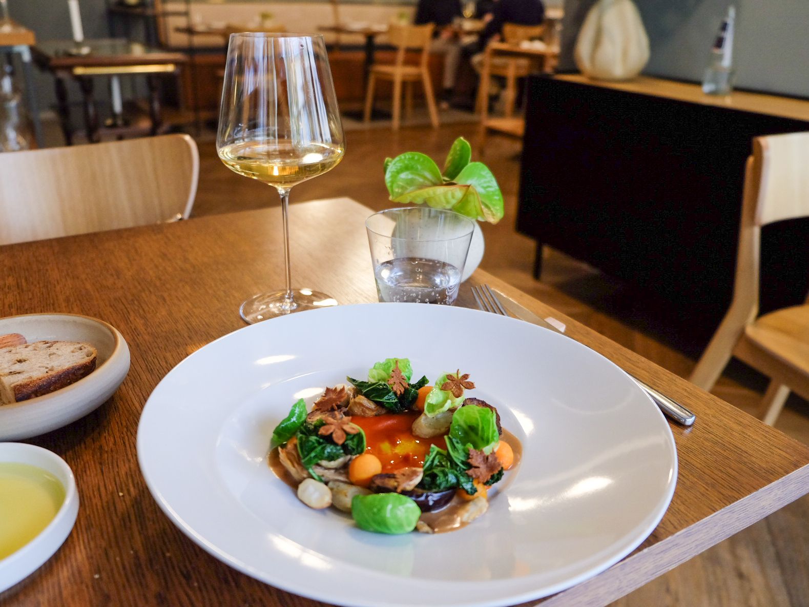 Images may contain food, food display, brunch, plates, cups, chairs, furniture, plants, adult accessories and bags