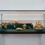 Golden artifacts in glass display cases.