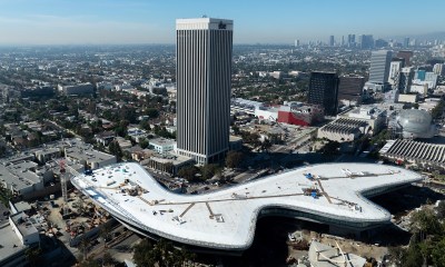 A museum amid a densely populated city seen from above.