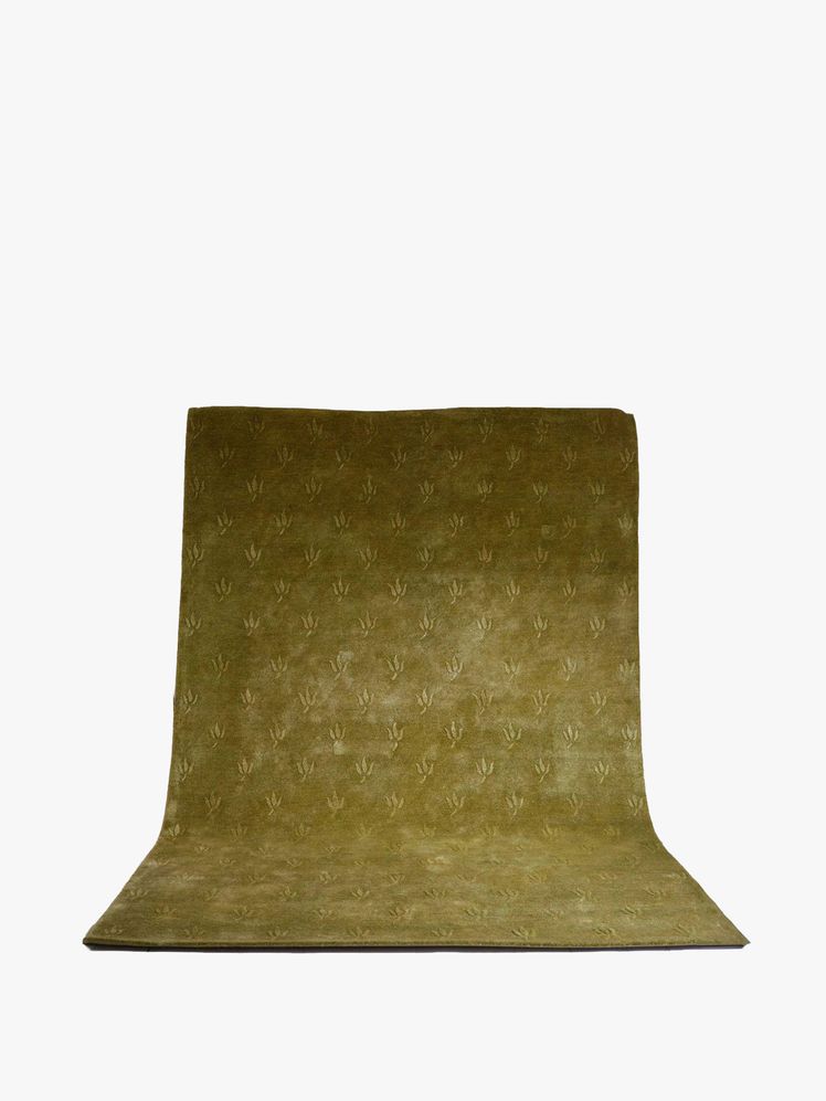 Image may contain: home decor, cushions, rug and pillows