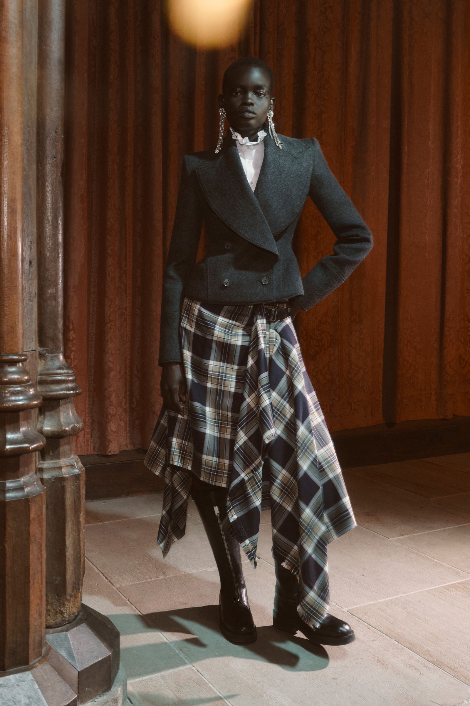 Image may contain clothing, skirt, tartan jacket, adults and people