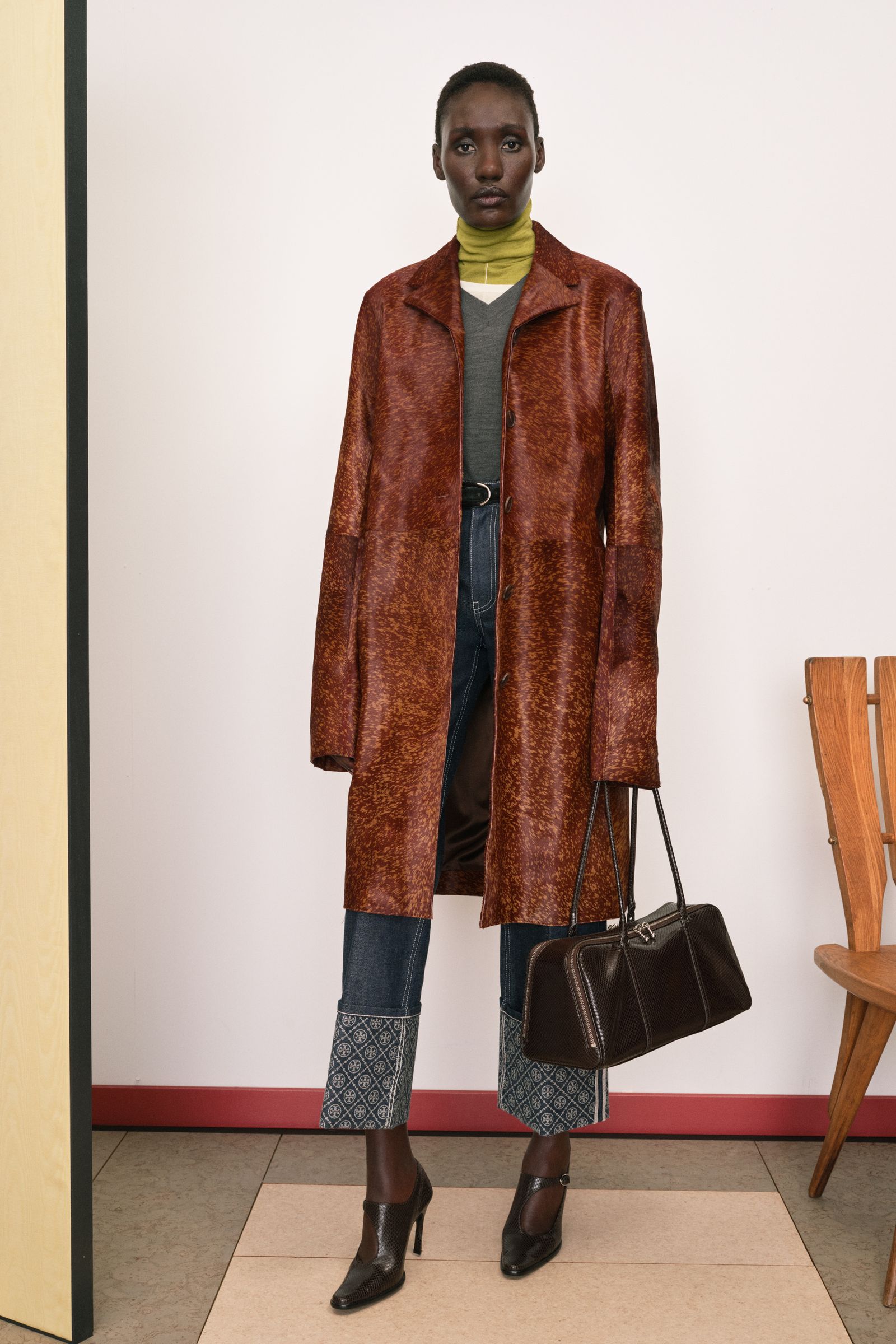 Image may contain Grace Jones clothing, outerwear, footwear, heels, shoes, jackets, coats, accessories, bags and handbags