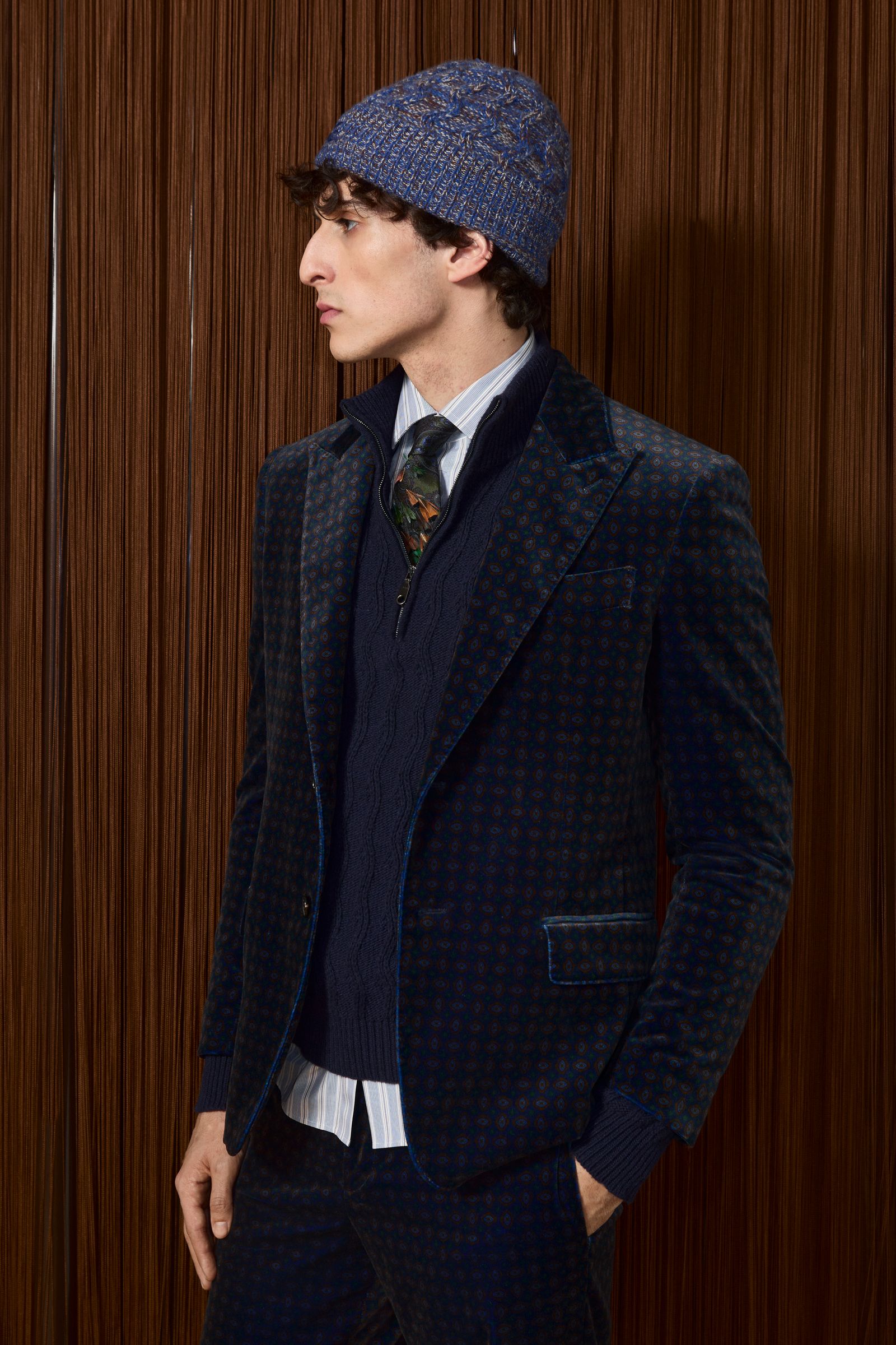 Image may contain clothing, coats, jackets, blazers, hats, formal suits, adult accessories, ties and faces