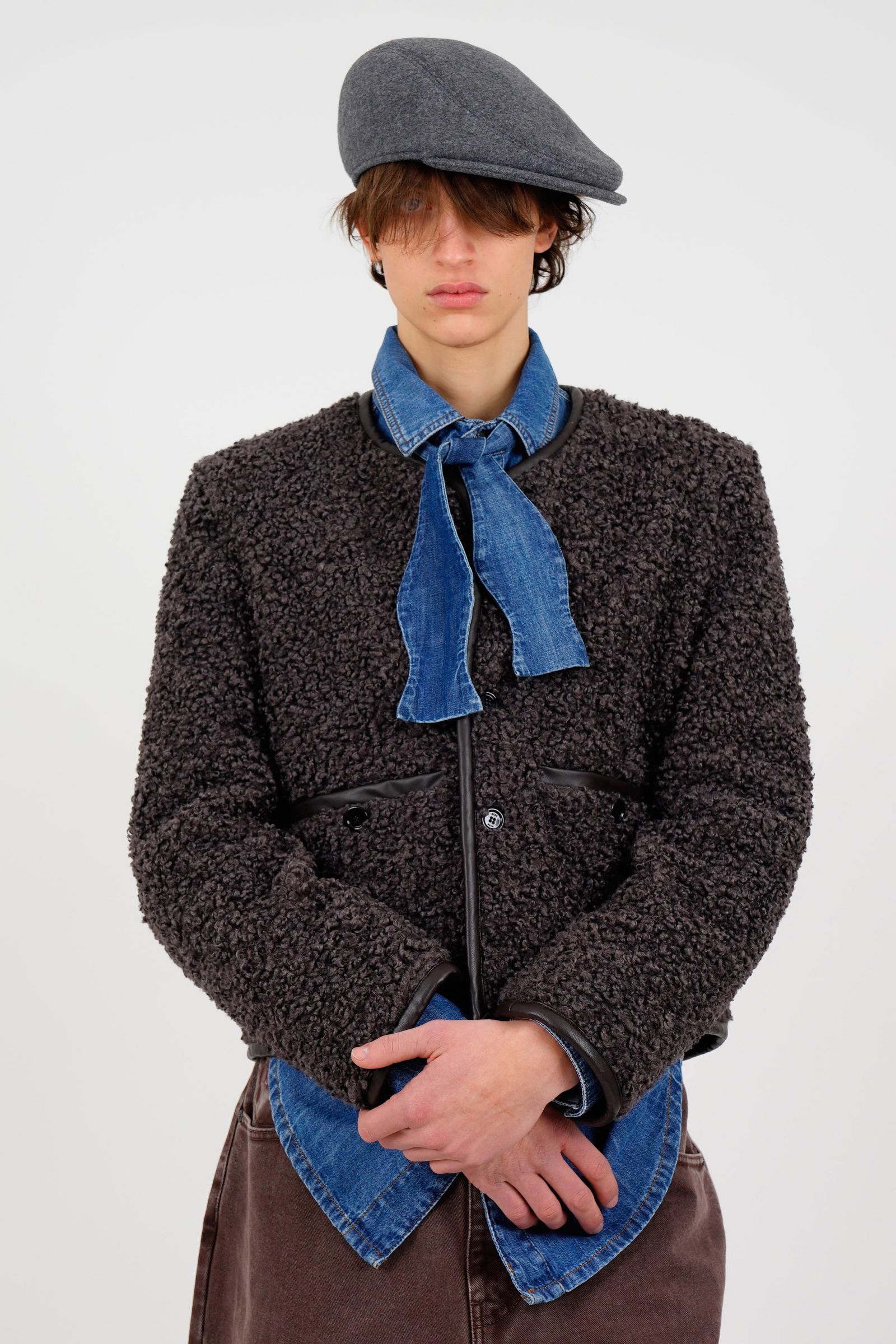 Image may contain clothing, coats, jackets, hats, knitwear, sweaters, scarves, adults and people