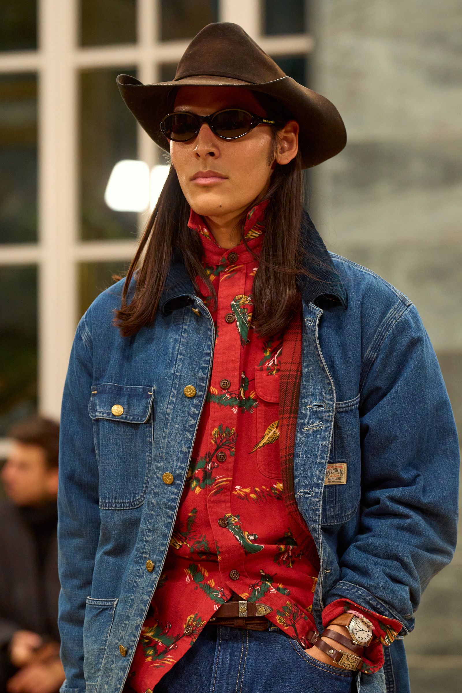 Image may contain clothing hats, coats, jackets, vests, pants, sun hats, adult faces, head accessories and sunglasses