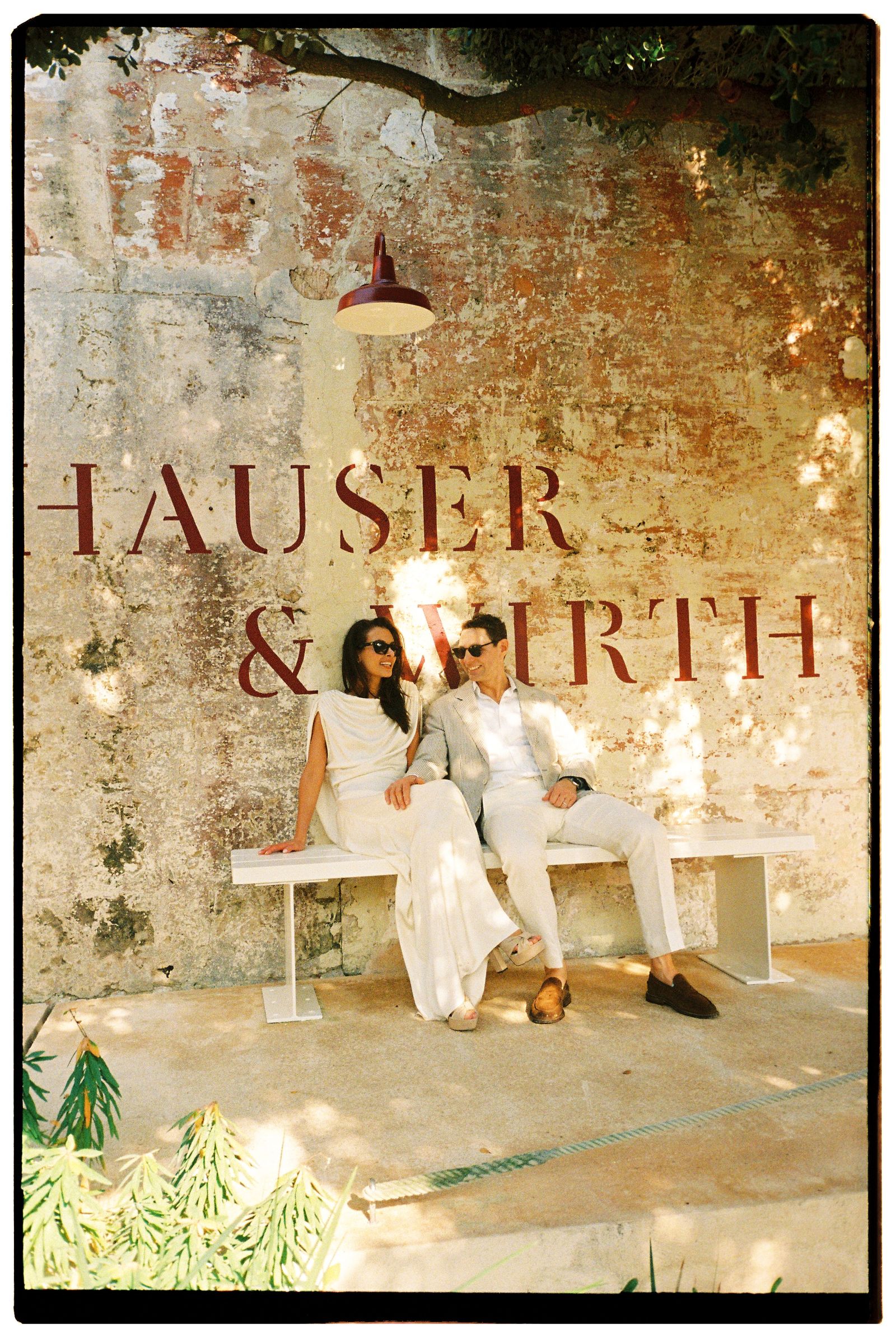 Images may contain faces, heads, people photography, portraits, clothing, dresses, pants, benches, furniture and formal wear