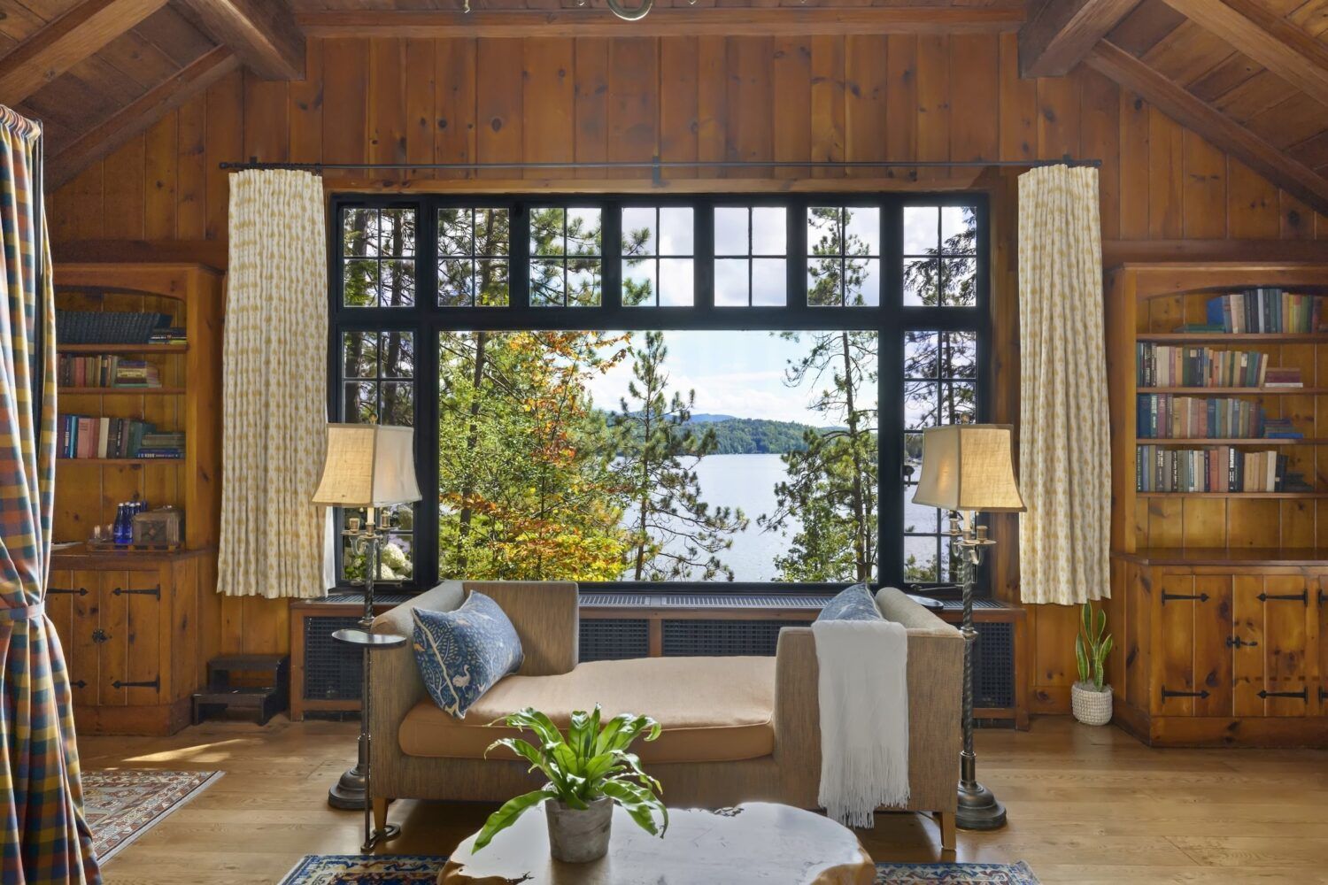 Image may contain interior interior design, plant lights, pictures, windows, windows, sofa, furniture, home decor, rug and table