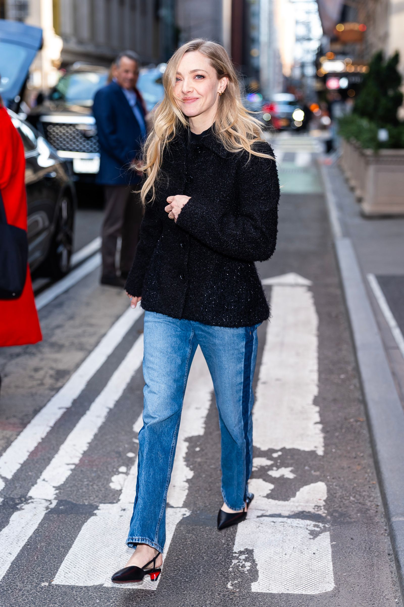 Image may contain Amanda Seyfried clothing, pants, jeans, adult, coat, blonde hair, car and traffic