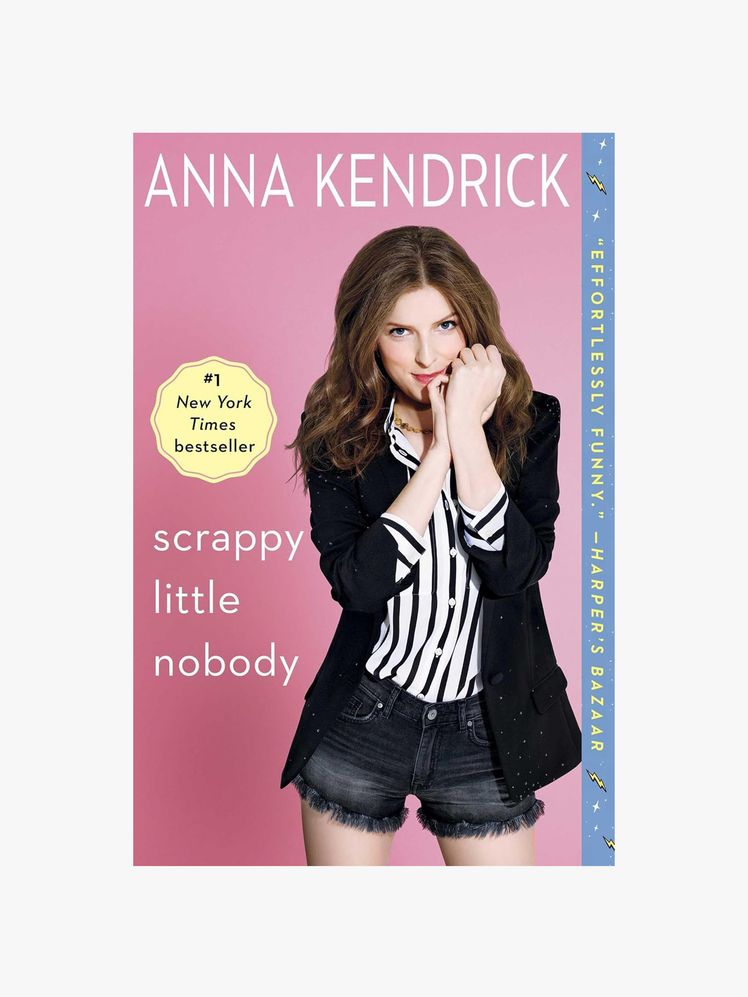 Image may contain: Anna Kendrick, Clothing, Coat, Publication, Jacket, Book, Blazer, Adult, Person, Face, and Head
