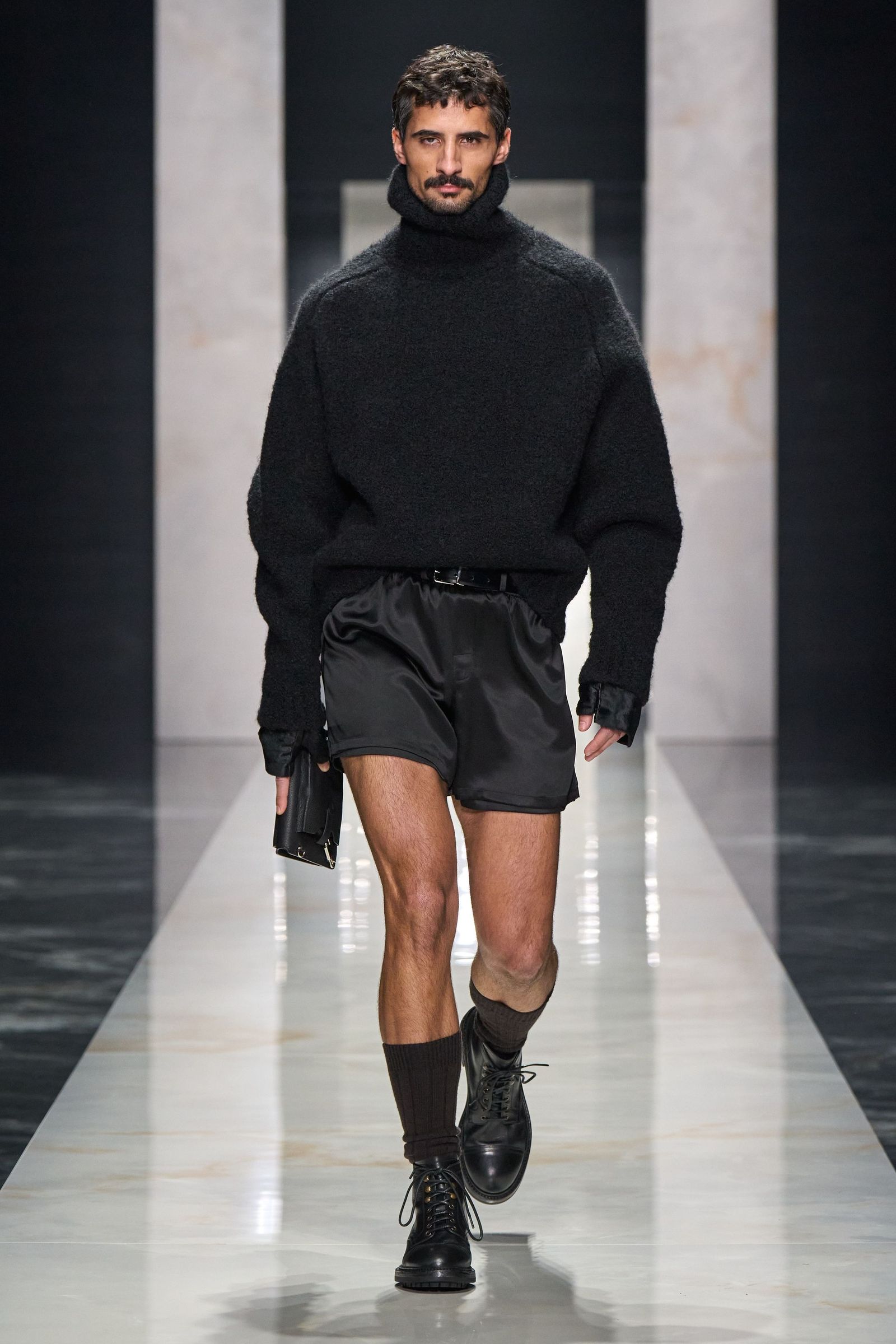 Image may contain fashionable adult clothing, shorts, knitwear and sweaters