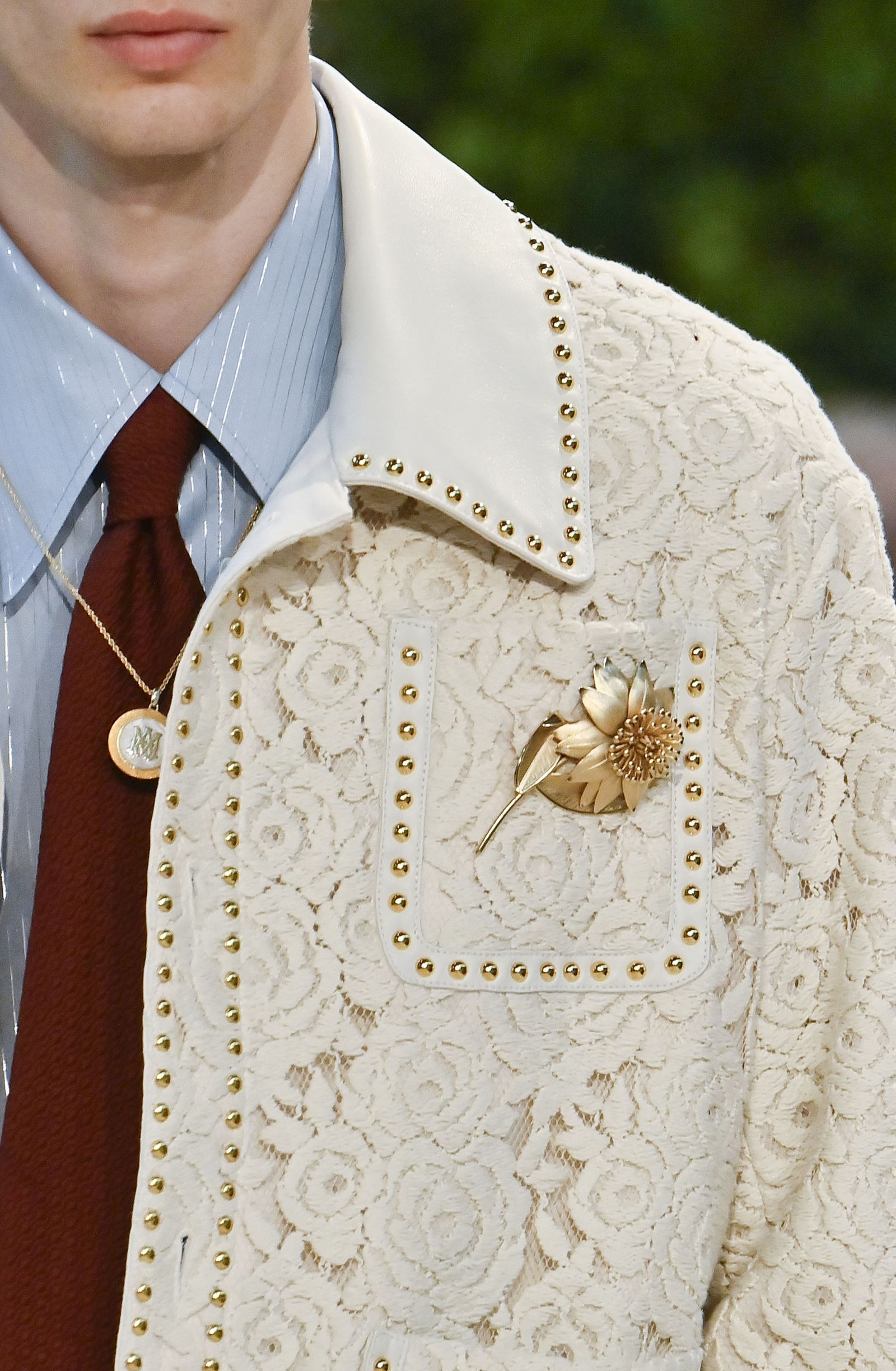 Image may contain clothing, coats, jackets, accessories, pendants, blazers, adult and wedding