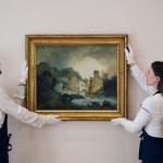 Two art handlers wearing white gloves hold JMW Turner's rediscovered landscape.