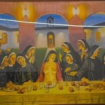 A painting of a feast with a nude woman in the center surrounded by a group of nuns.