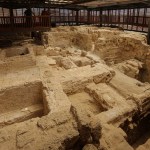 Archaeological site surrounded by railings.